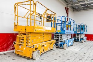 Scissor lifts: devices with a boom on a chassis with wheels and a large work platform